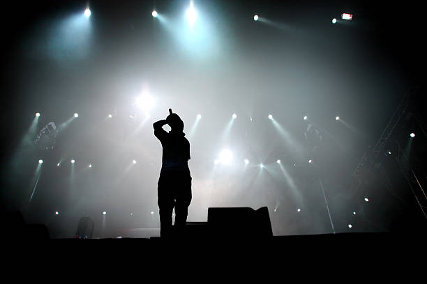 Silhouette of hip hop singer on stage.